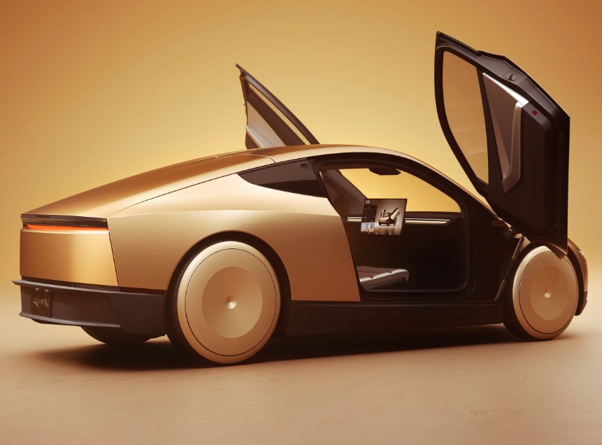 A gold futuristic car with gull-wing doors open, showcasing a sleek and minimalist design.