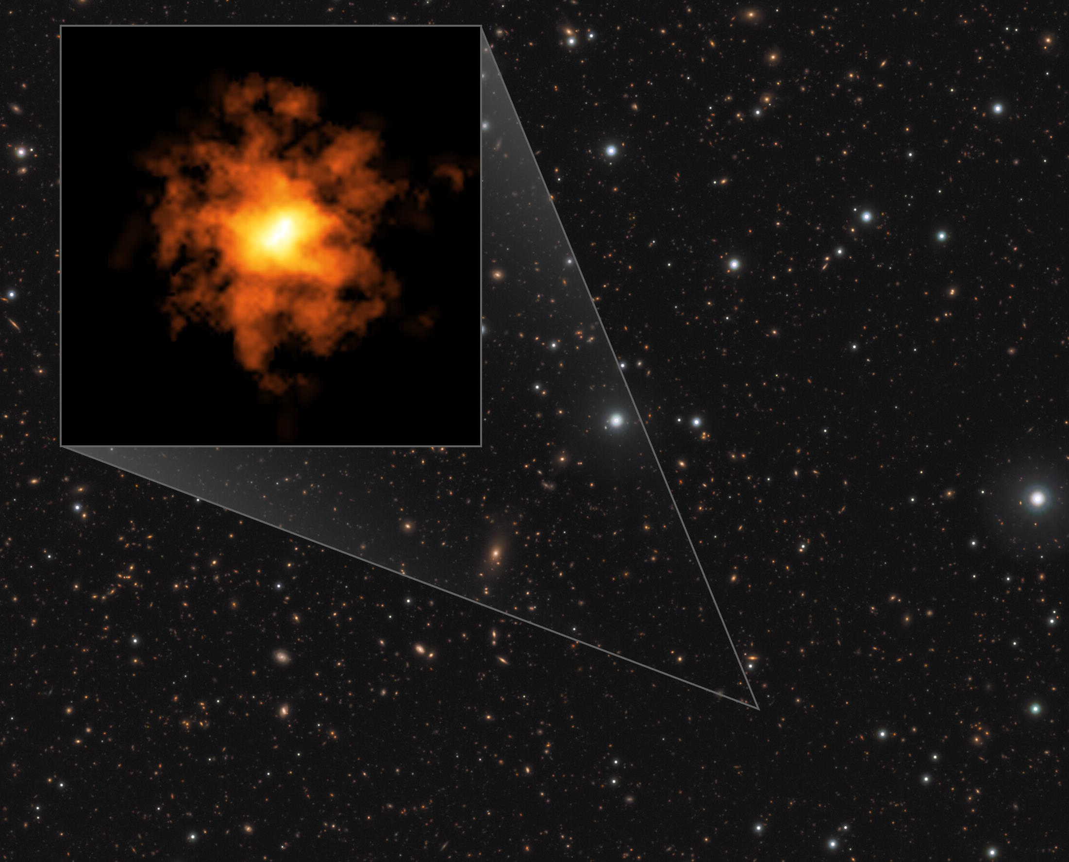 An orange and yellow galaxy cluster, reminiscent of the youngest formations in the universe, rotates elegantly against a backdrop of distant stars in space.