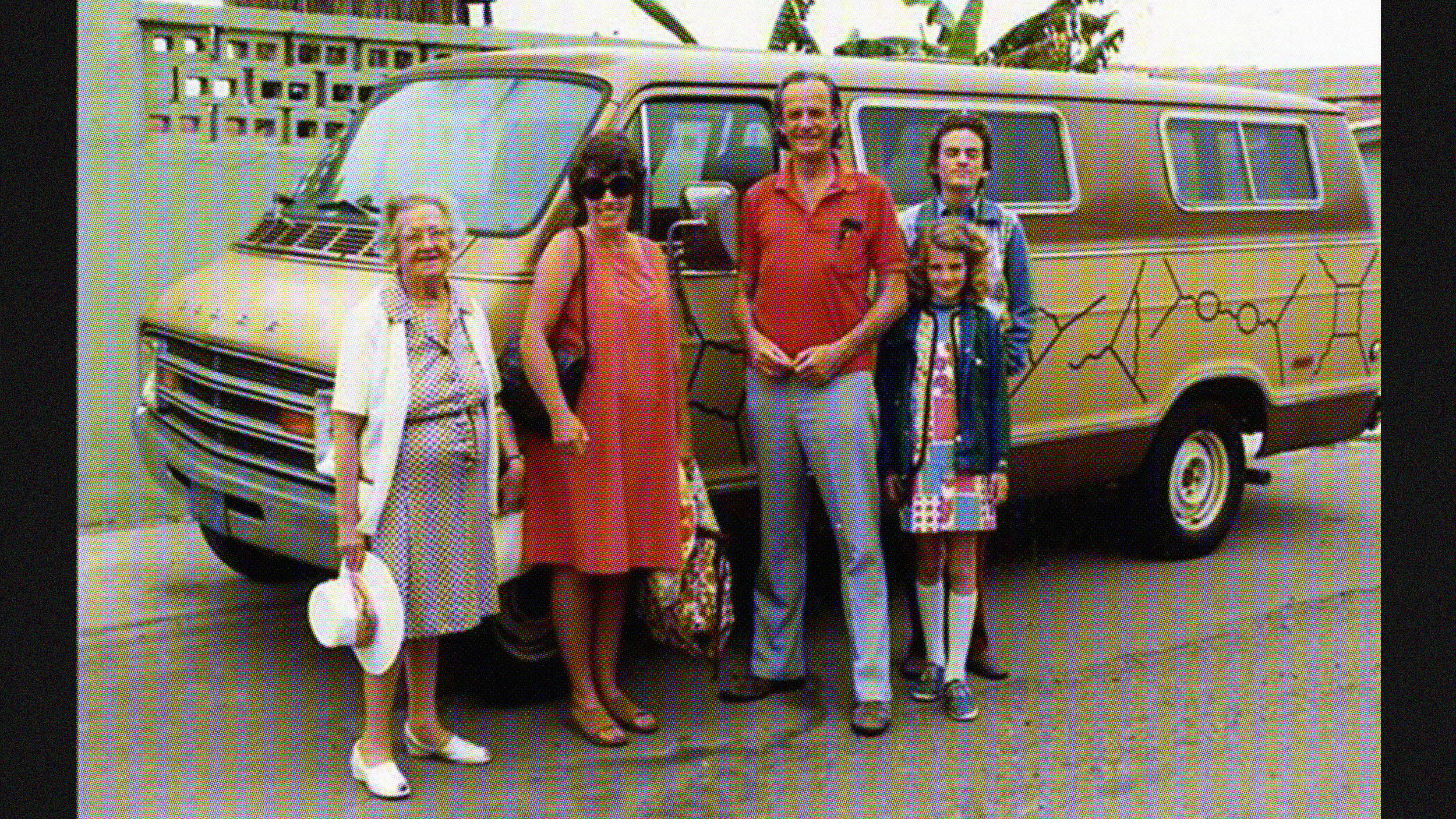 A group of five people stands in front of a brown van, channeling their inner Richard Feynman. The background features a wall adorned with lush plants, setting the perfect scene for these everyday heroes.