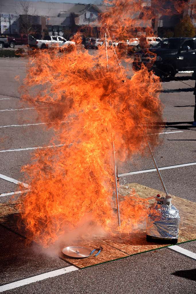 During a dramatic demonstration in a parking lot, a massive fireball erupted from a propane tank setup, illustrating the dangers of attempting to deep fry a frozen turkey.