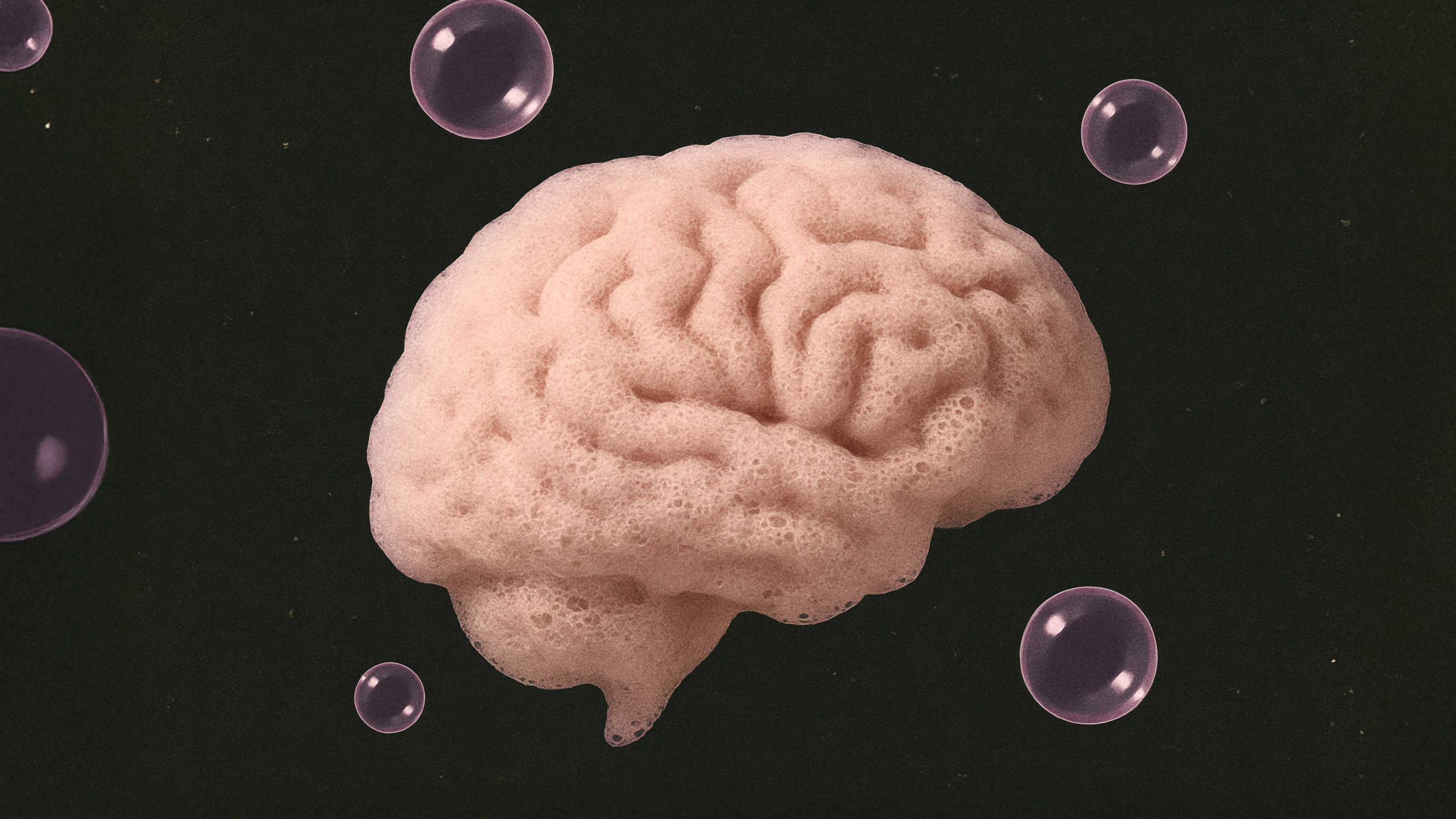 A foam structure shaped like a human brain is surrounded by translucent bubbles on a black background.